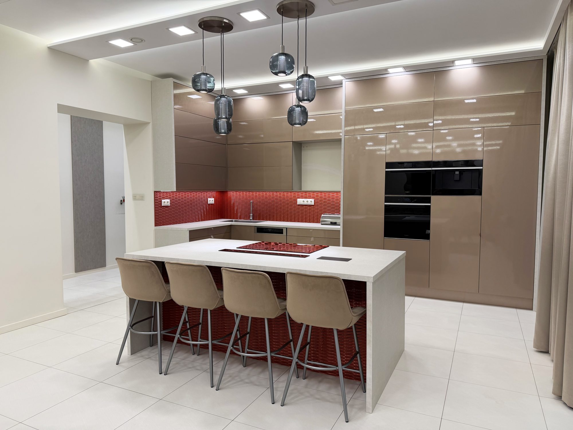 Kitchen with island, bar stools and built-in appliances